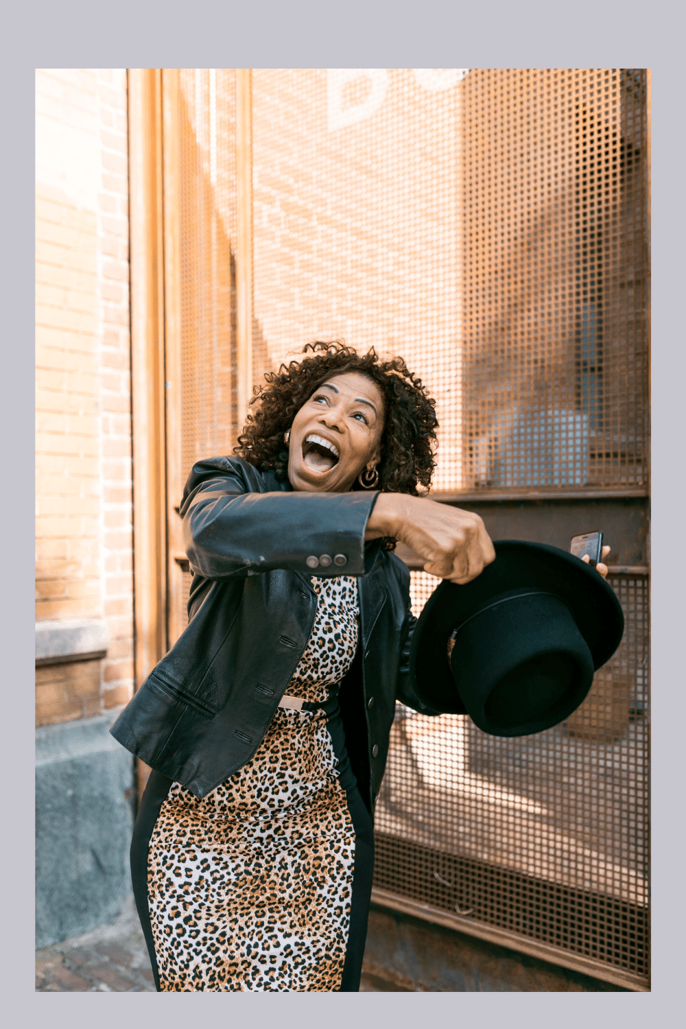 Woman in Leopard Dress and a Leather Coat