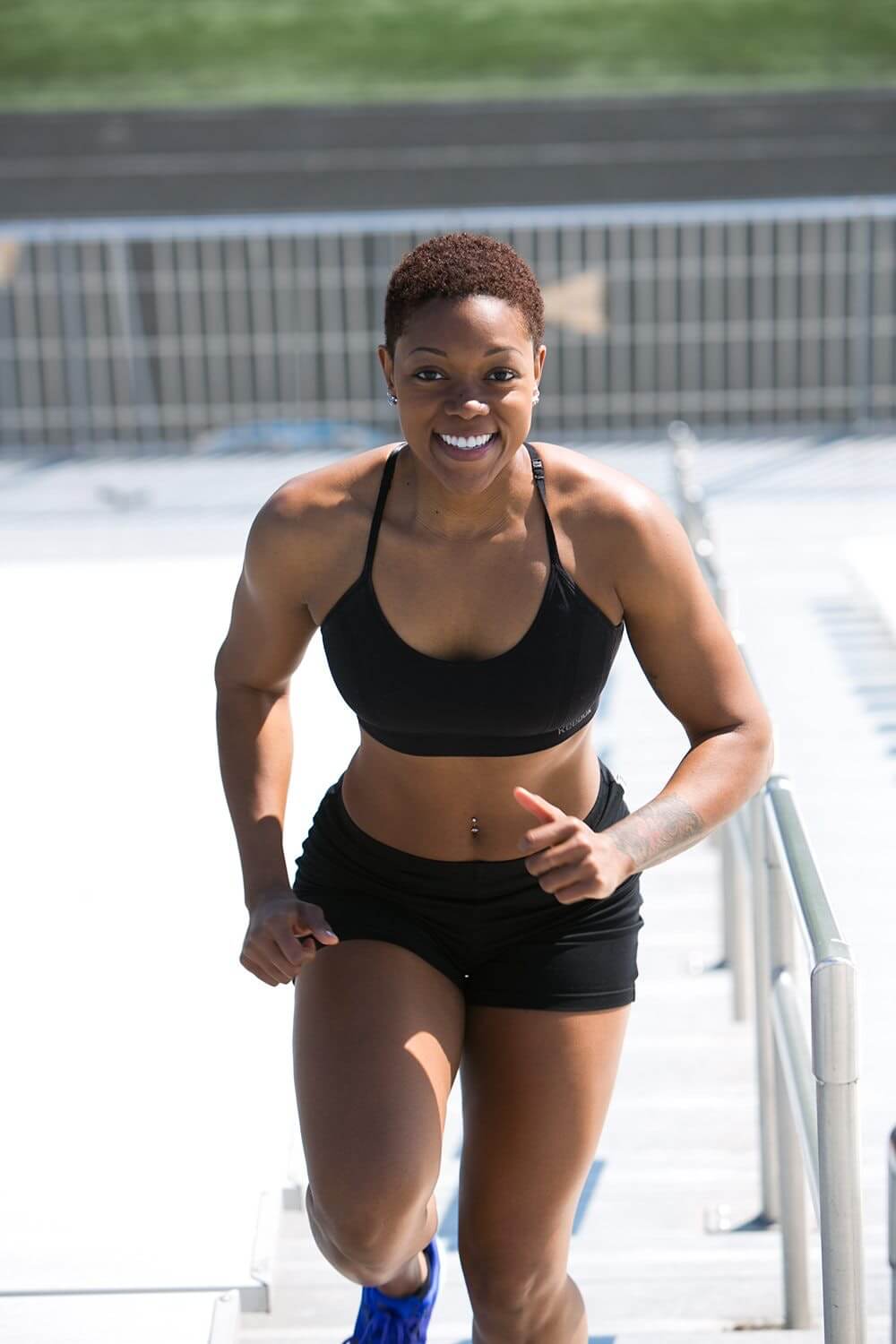 Woman Running Upstairs in Workout Shorts